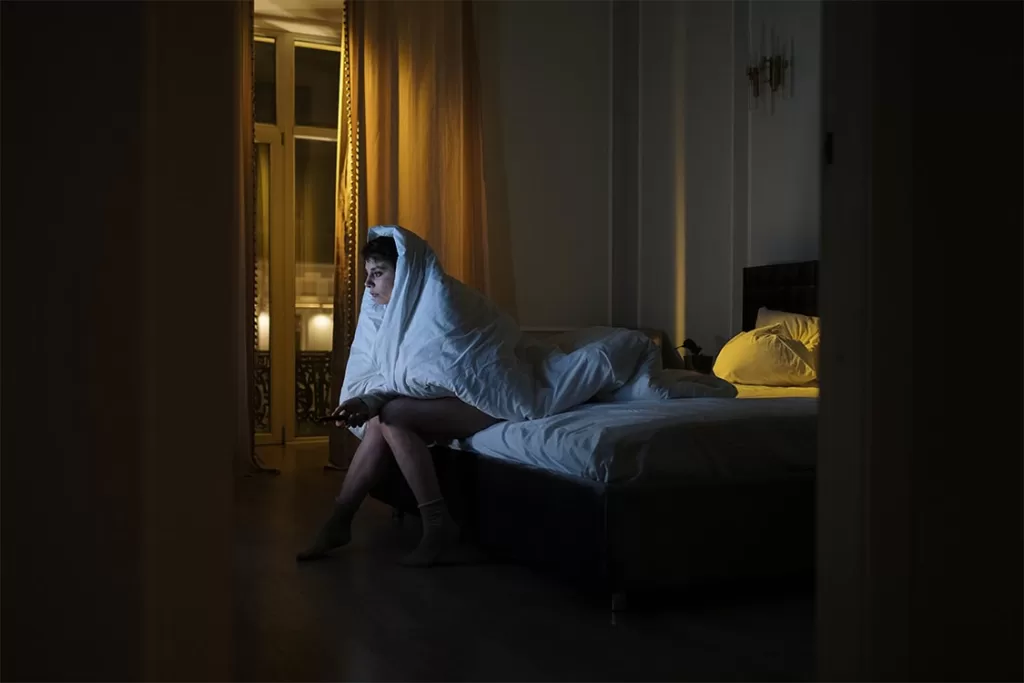 Girl-with-Insomnia-watching-tv-at-night Girl with insomnia watching tv late at night in bed