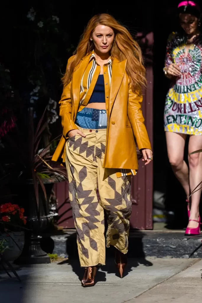 f44e8a9d0f04c8cf_GettyImages-1493299179-2 Blake Lively wearing a yellow leather jacket and double pants as Lily Bloom in movie adaptation of Colleen Hoover's book "It Ends with Us"